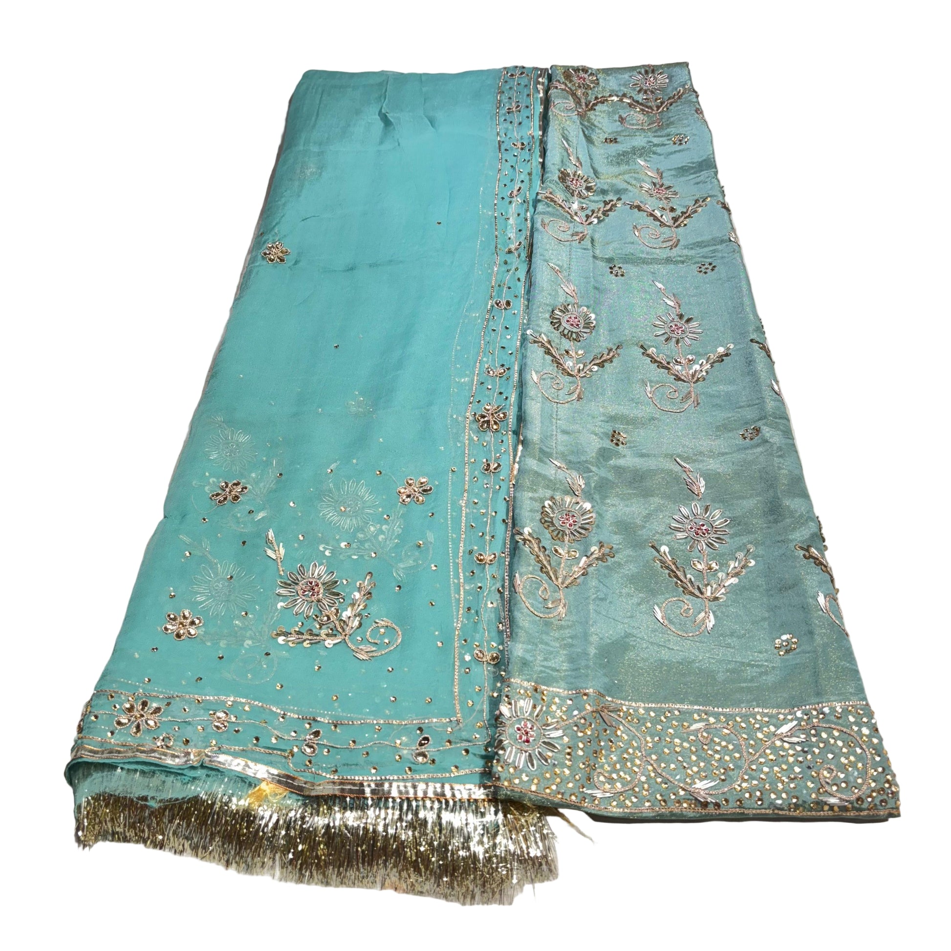 Turquoise embroidered fabric on a white background