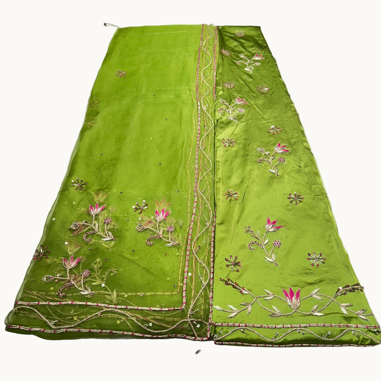 Green embroidered fabric on a white background