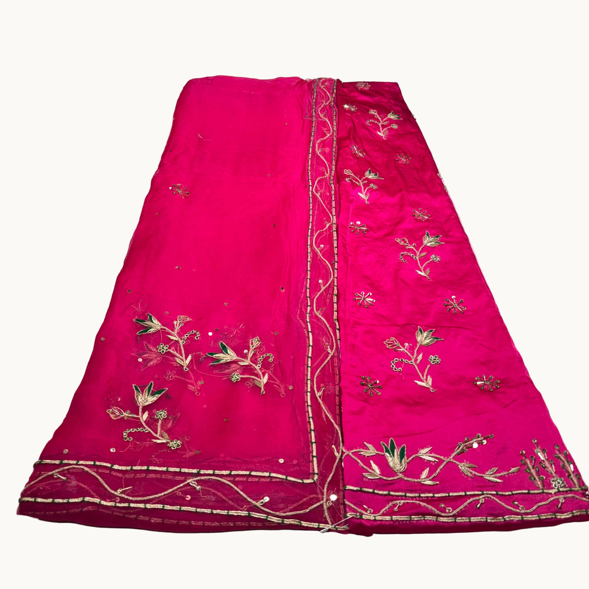 Pink embroidered fabric on a white background