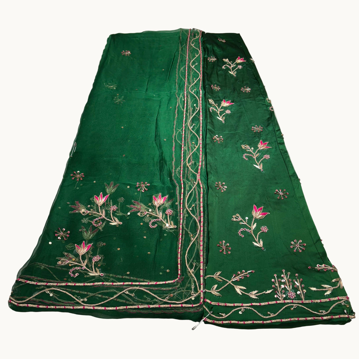 Green embroidered fabric on a white surface
