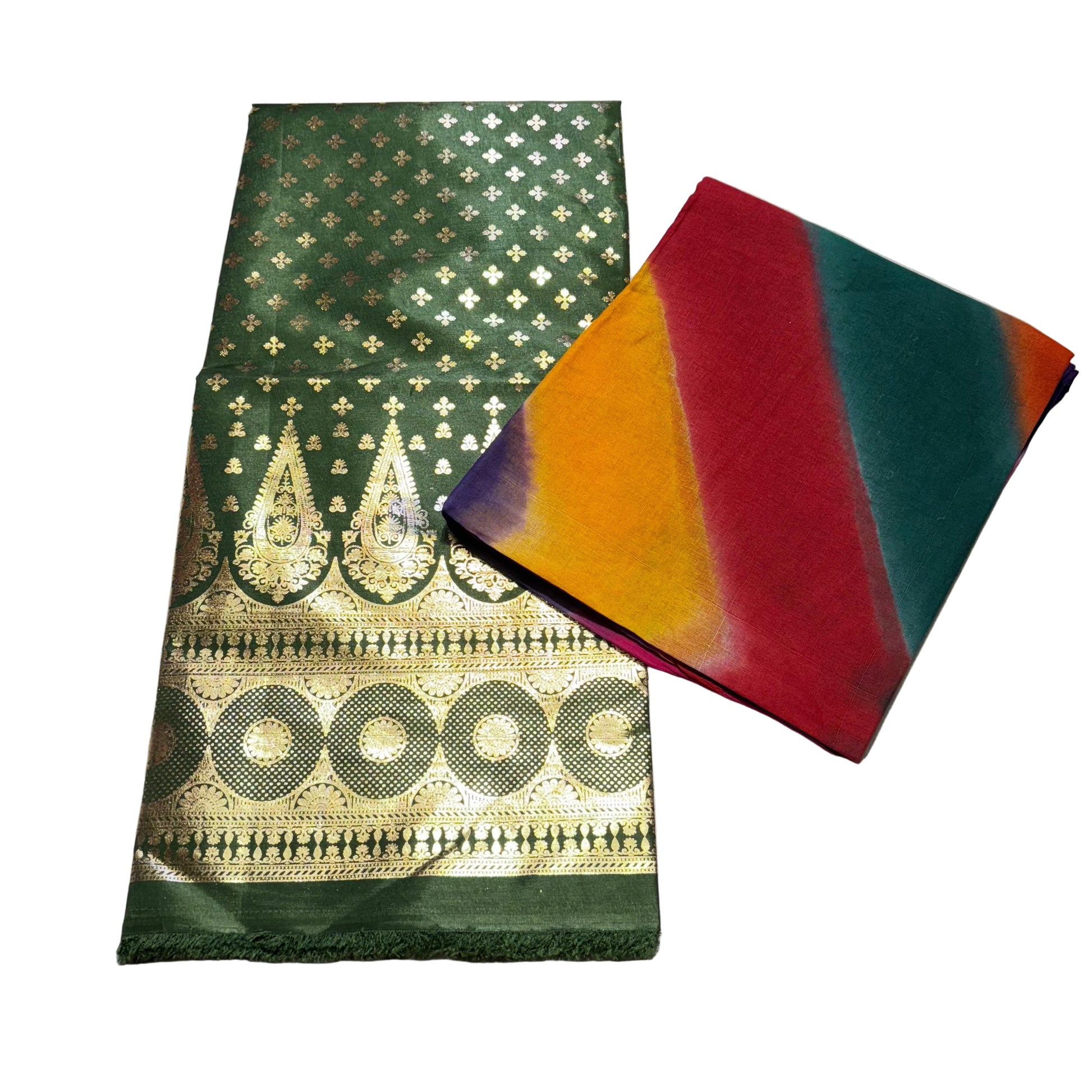 Two folded fabrics on a light gray surface, one green with gold patterns and the other multicolored.