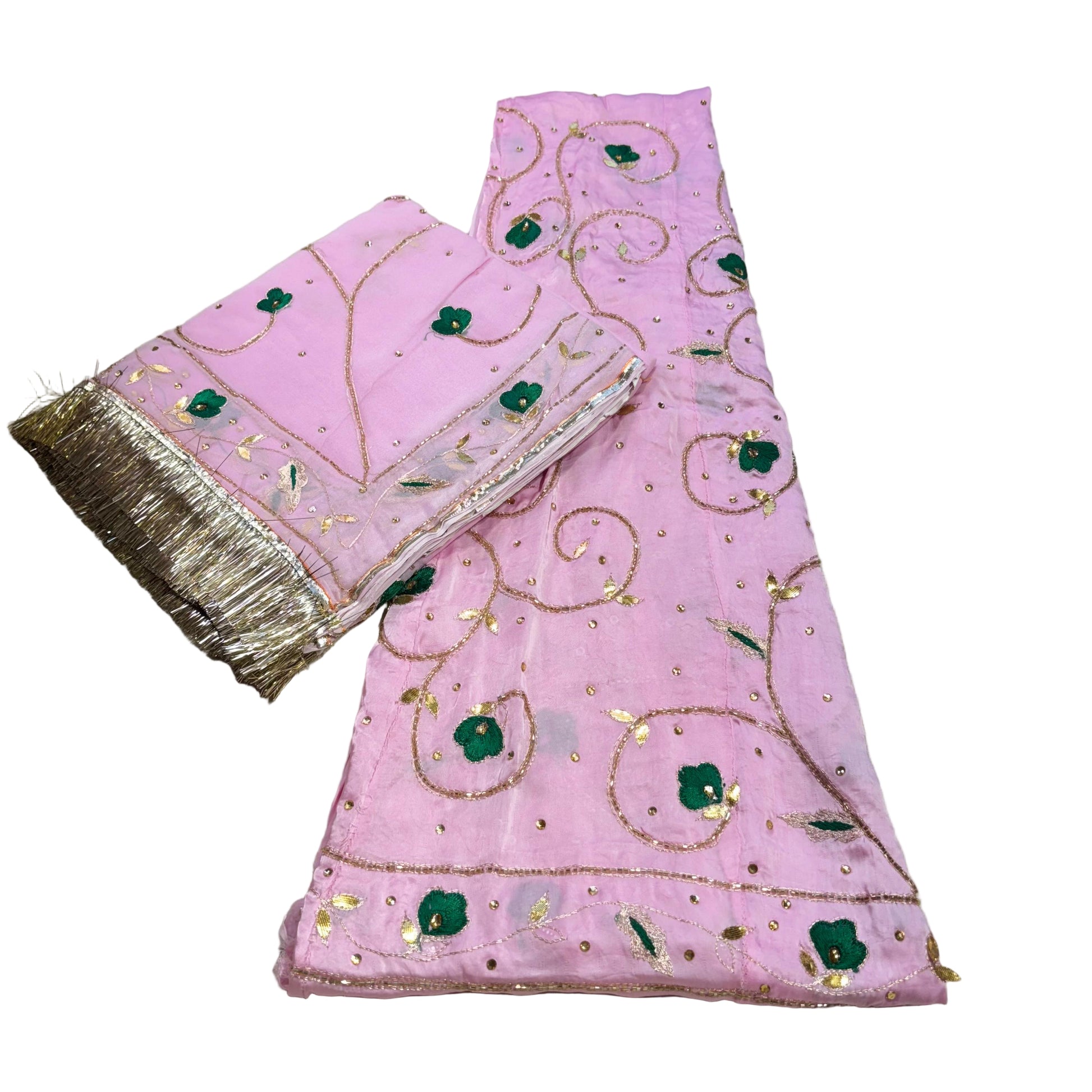 Pink embroidered fabric with gold and green patterns on a beige background