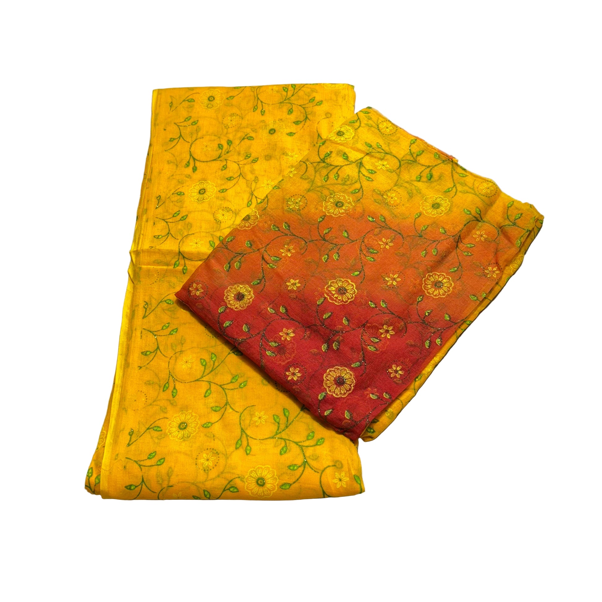 Two fabric swatches, one yellow with green patterns and one red with gold patterns, on a gray surface.