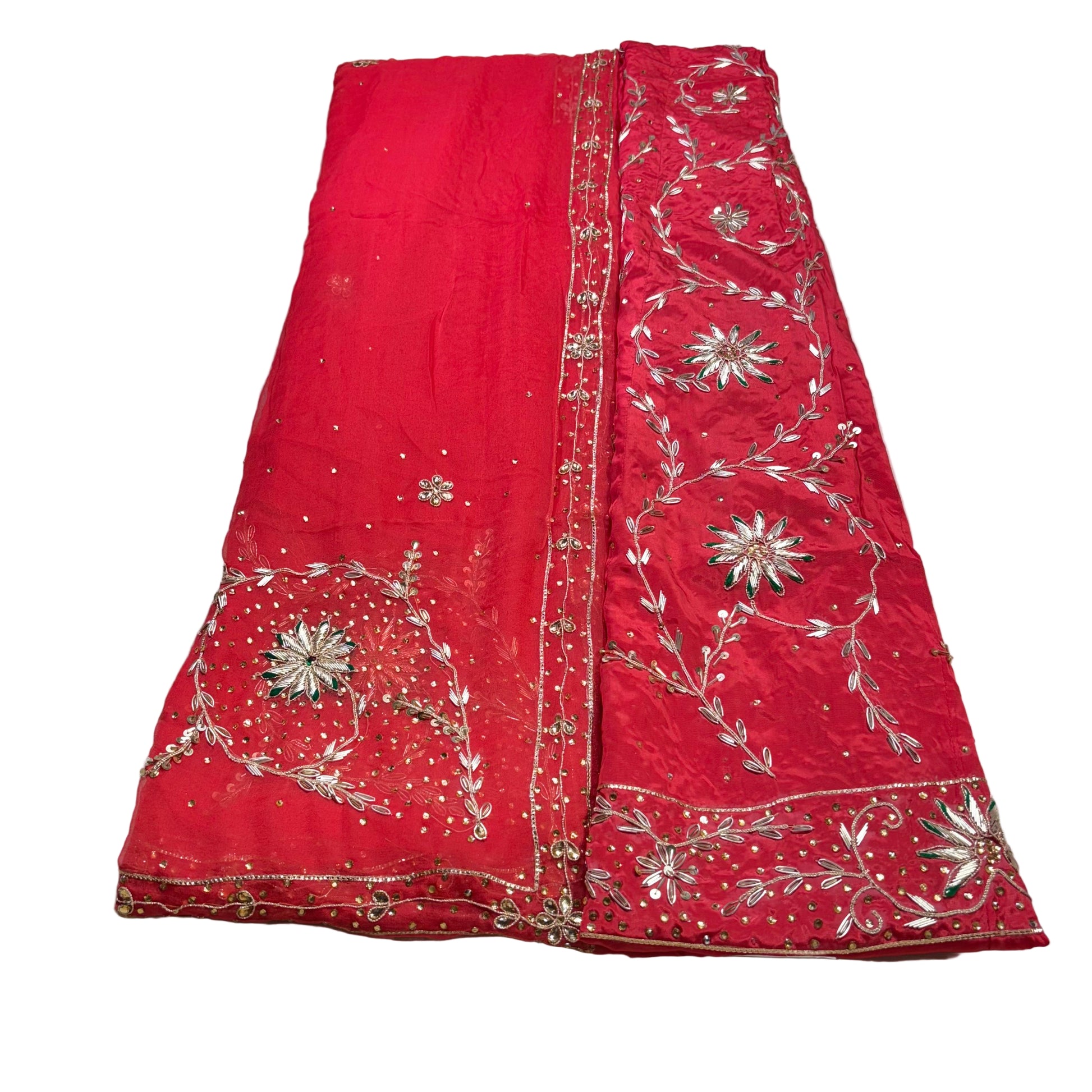 Red embroidered fabric on a light gray surface