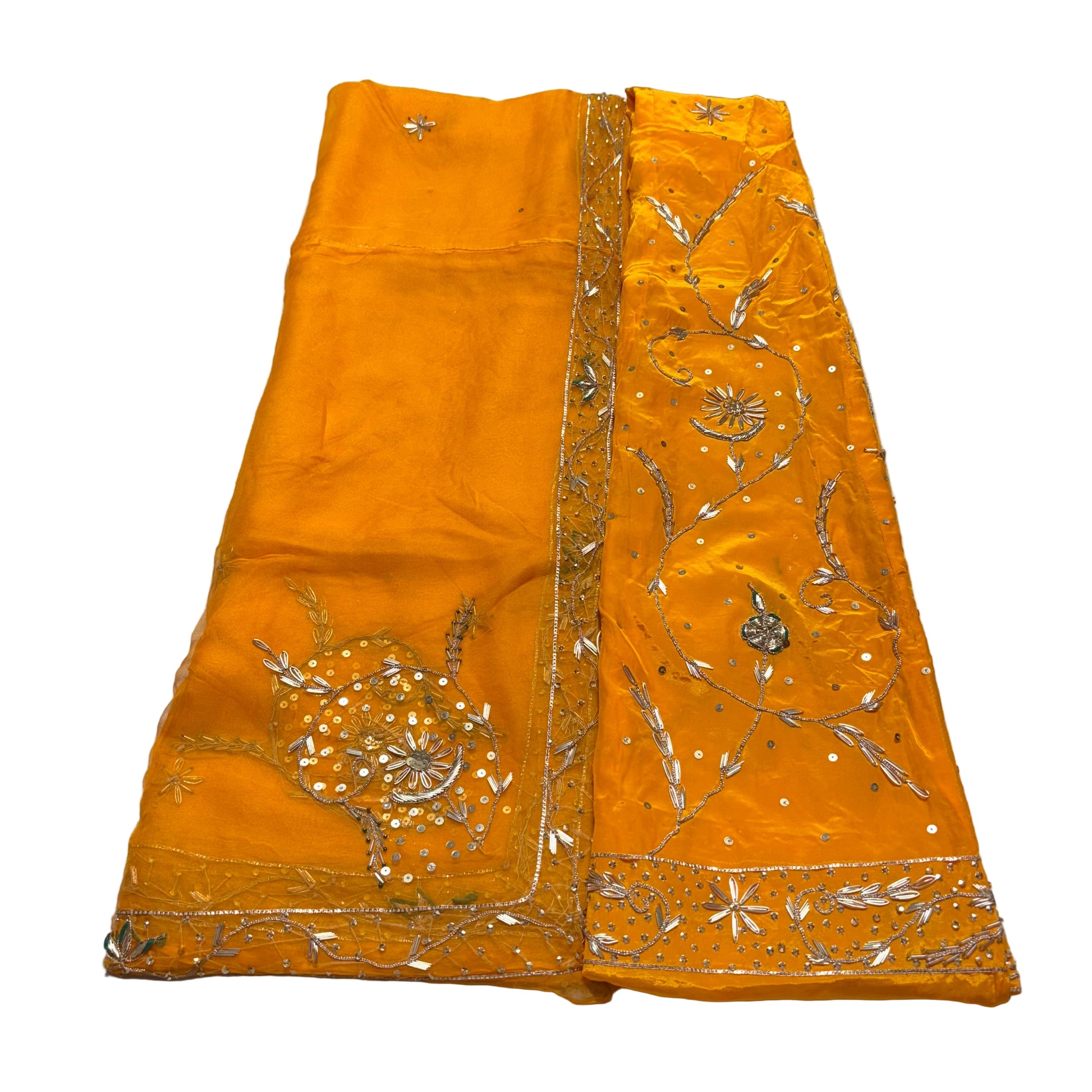 Orange fabric with gold embroidery on a gray surface