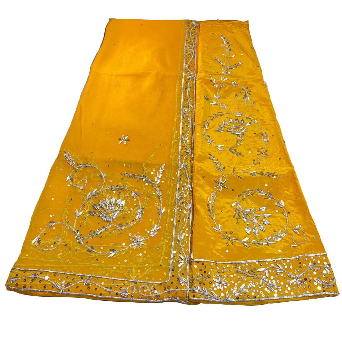 Yellow fabric with silver embroidery on a light gray background