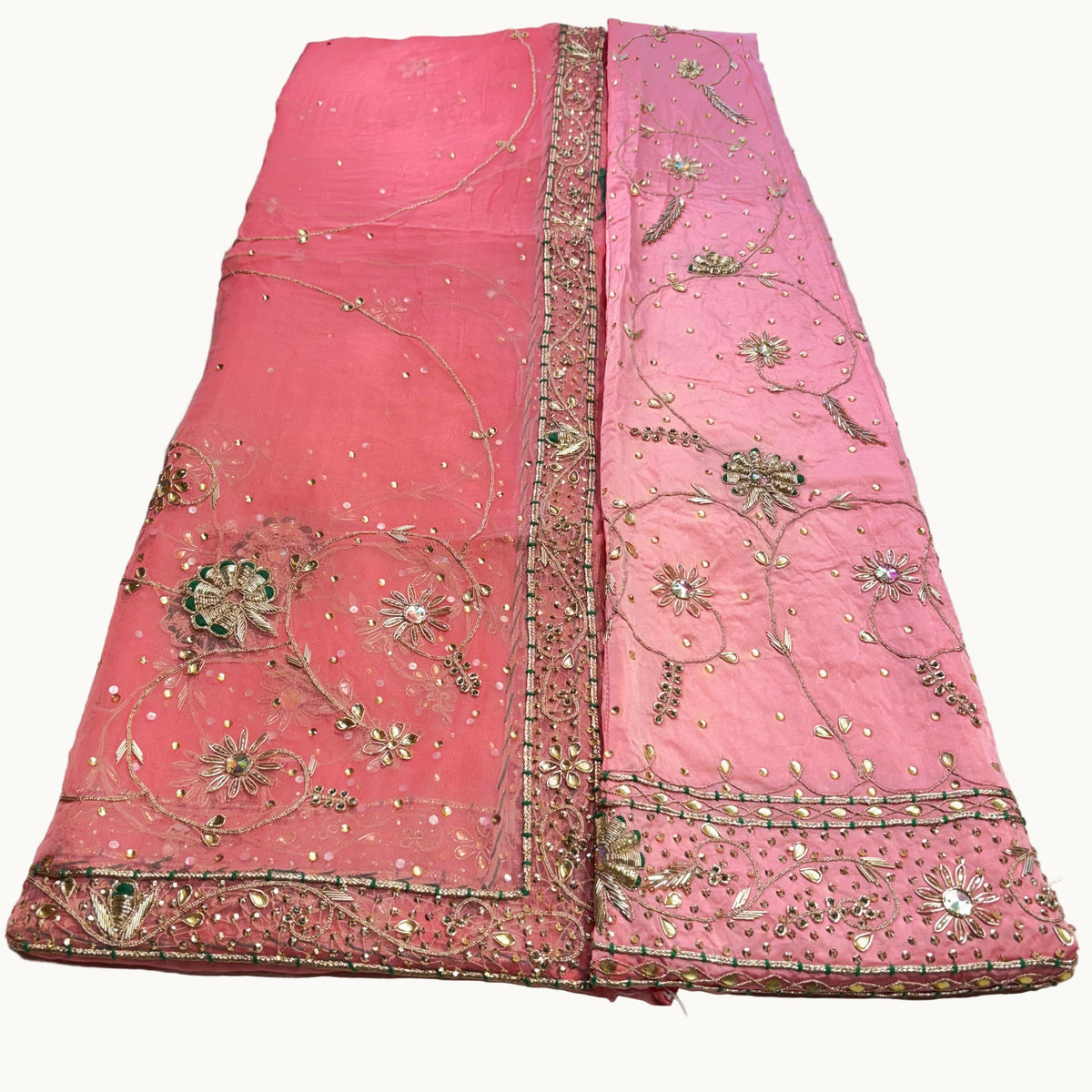 Pink embroidered fabric on a light gray background