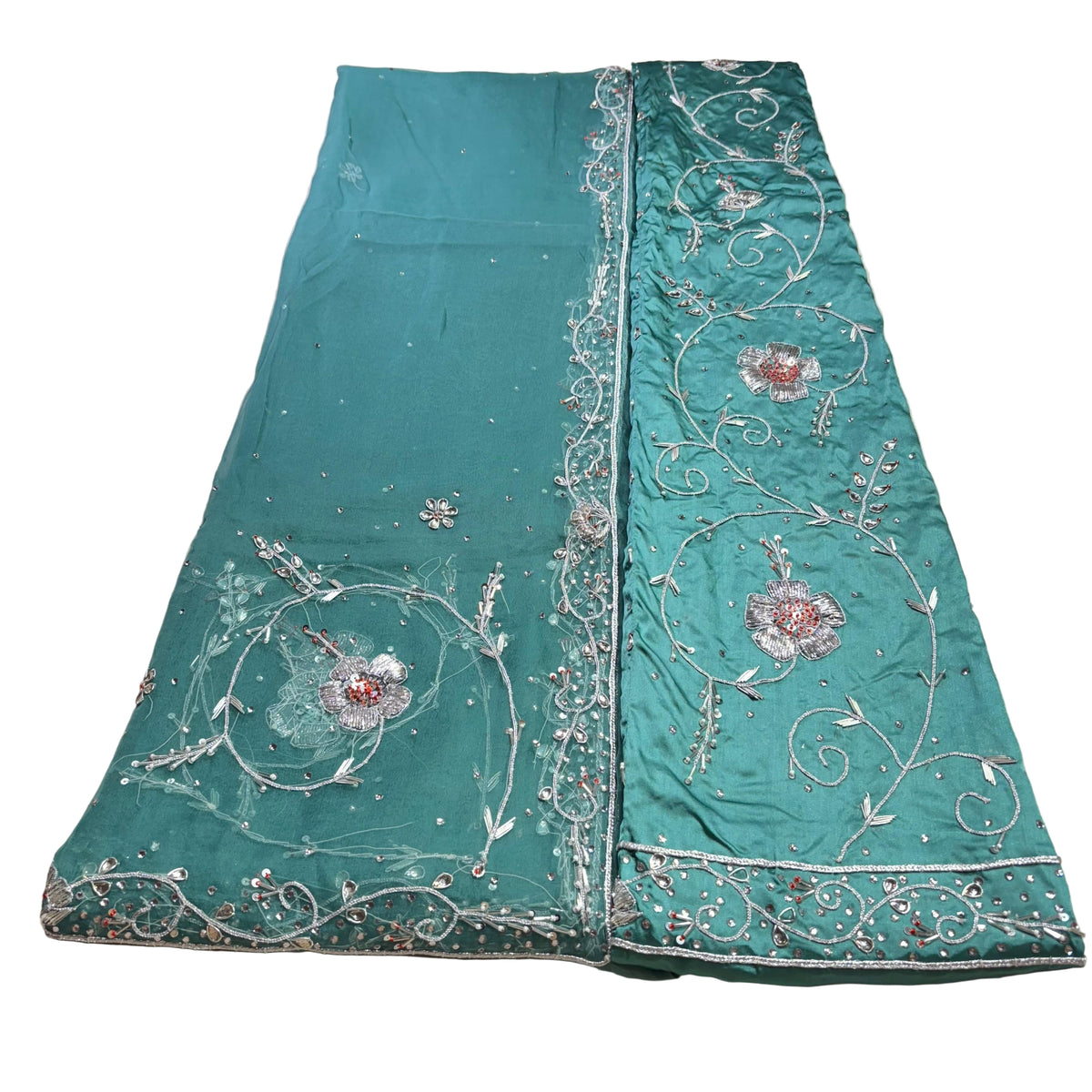 Teal fabric with intricate silver embroidery on a light background