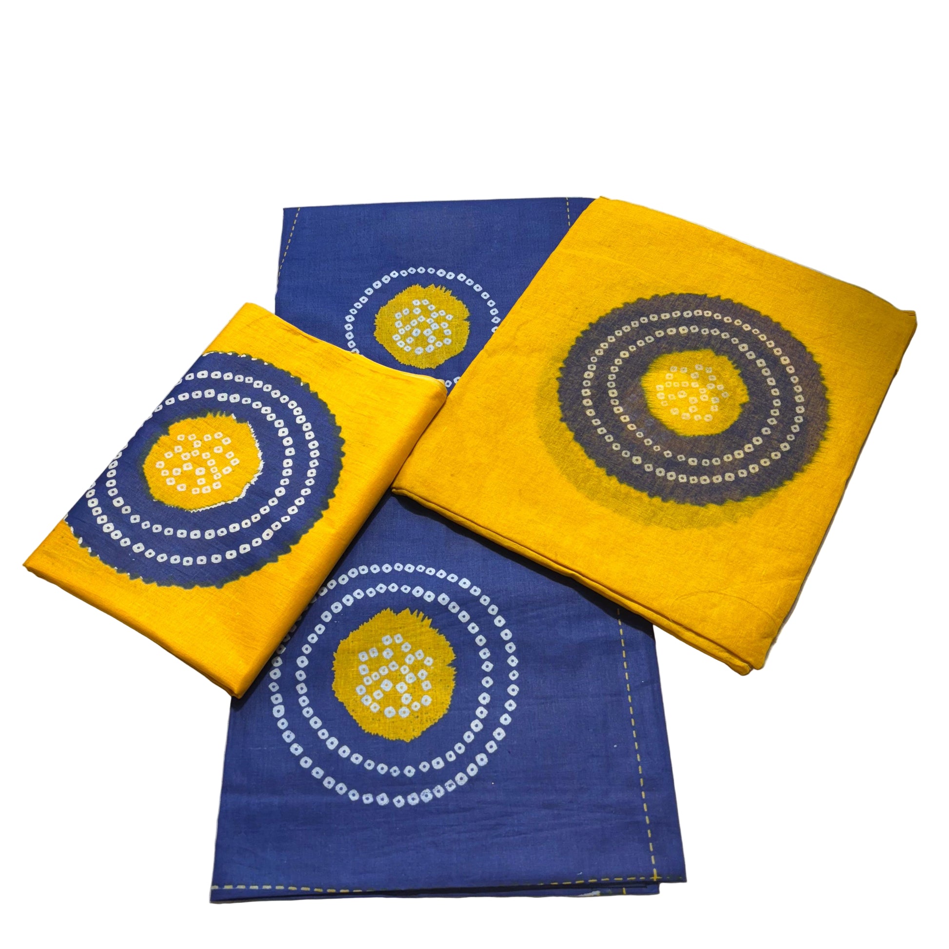 Three fabric pieces with circular patterns on a textured surface