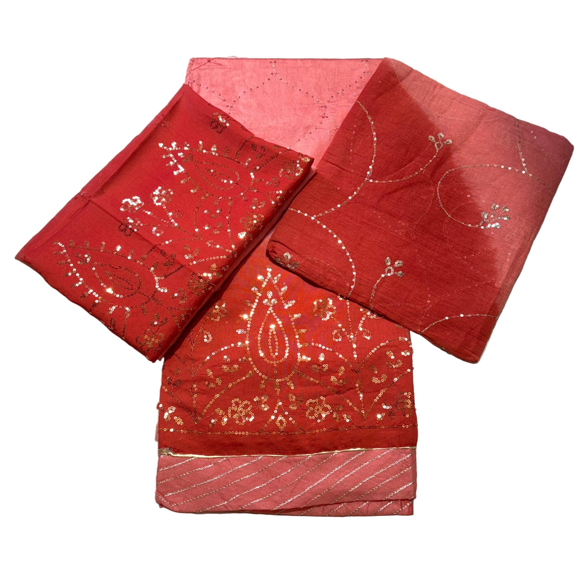 Red fabric with gold patterns on a light gray background