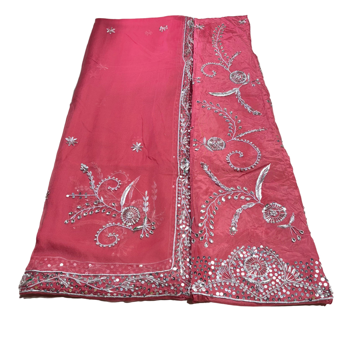 Red fabric with silver embroidery on a light gray background