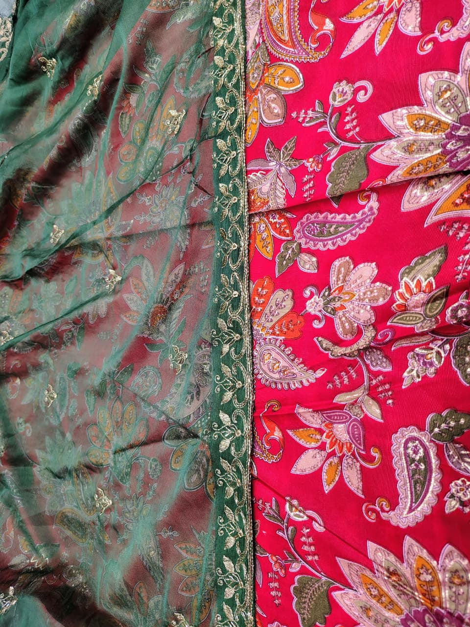 Close-up of a saree with floral patterns and green border