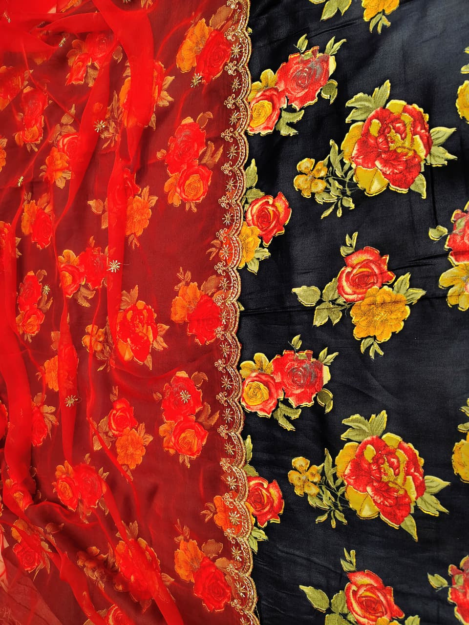 Embroidered fabric with red and yellow floral patterns on a black background