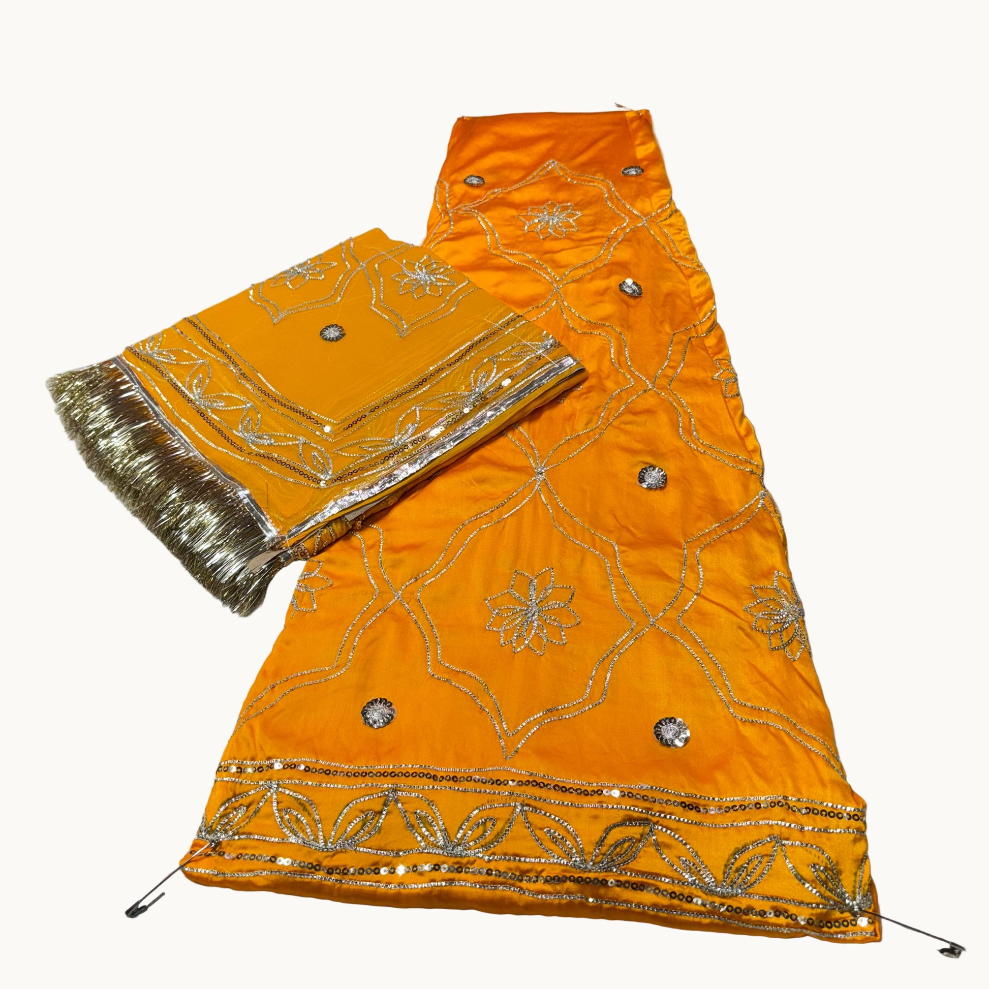 Orange fabric with gold embroidery on a white background