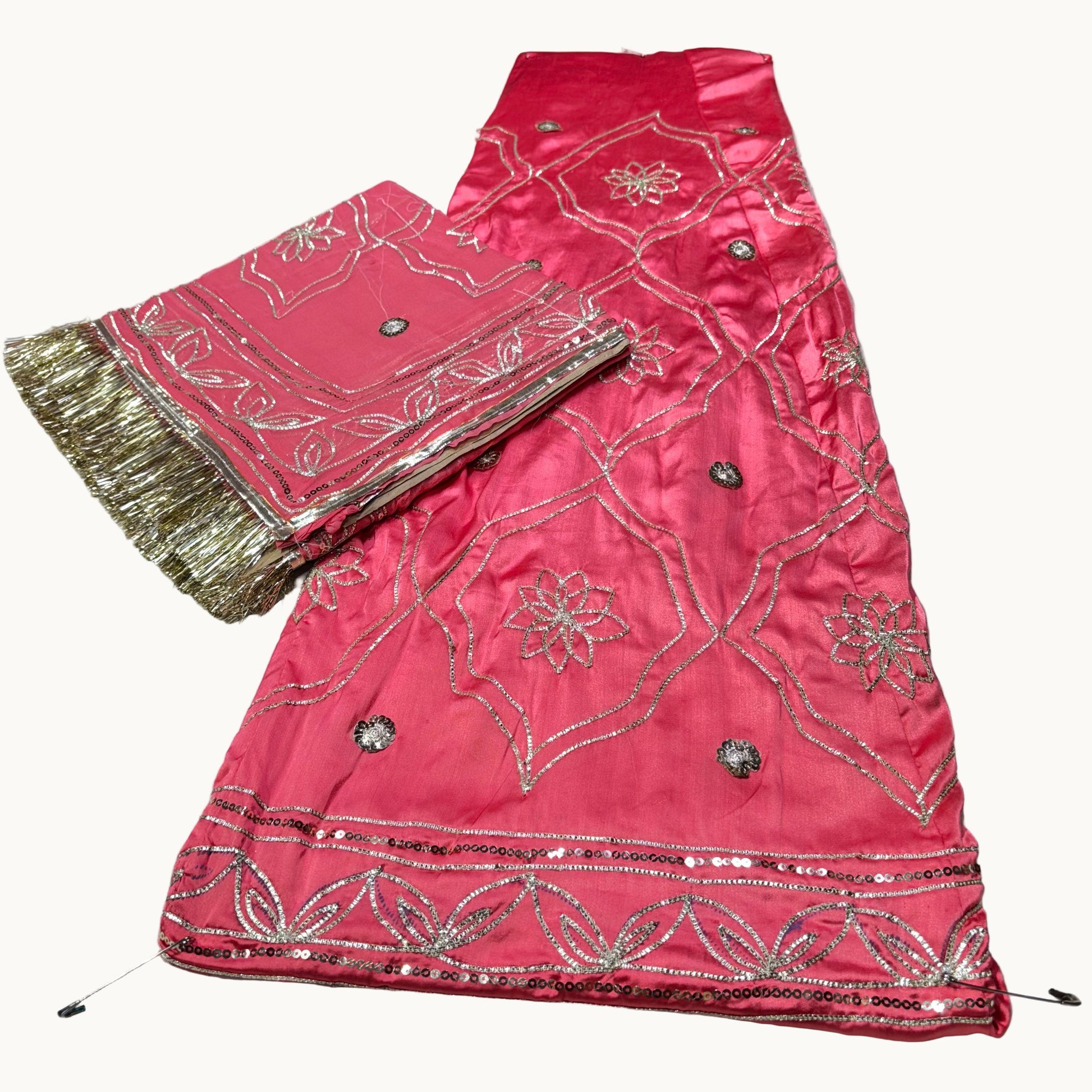 Pink embroidered fabric with gold border on a light gray background
