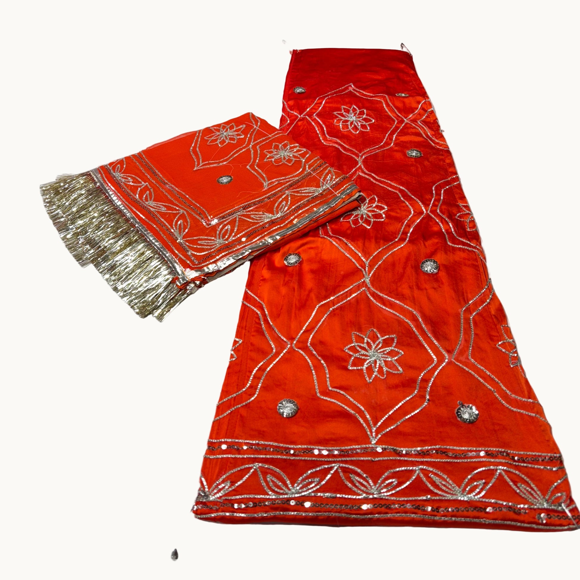 Red embroidered fabric with gold border on a white background