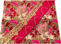 A folded textile with a rich magenta pink and light pink background, decorated with an intricate gold paisley and floral pattern, and a matching metallic gold border.