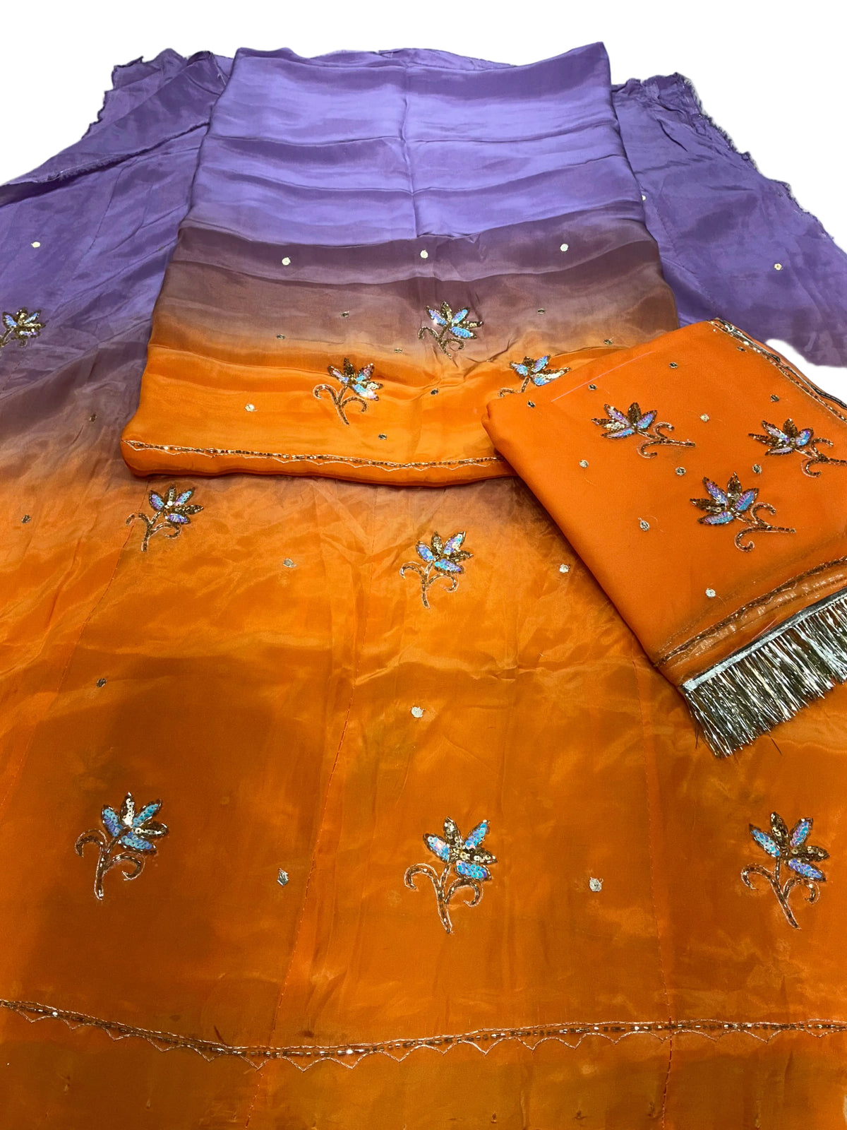 Lavender colour Rajputi poshak fabric set, lavender top shading to orange, with sequin flower butti and an orange odhni with silver fringe