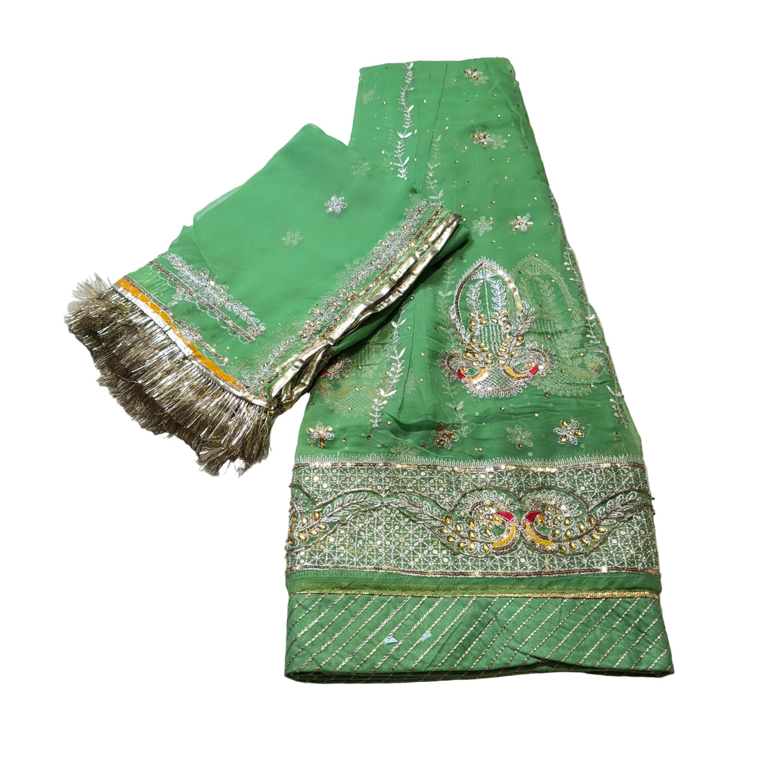 Green embroidered fabric with gold detailing on a light gray background