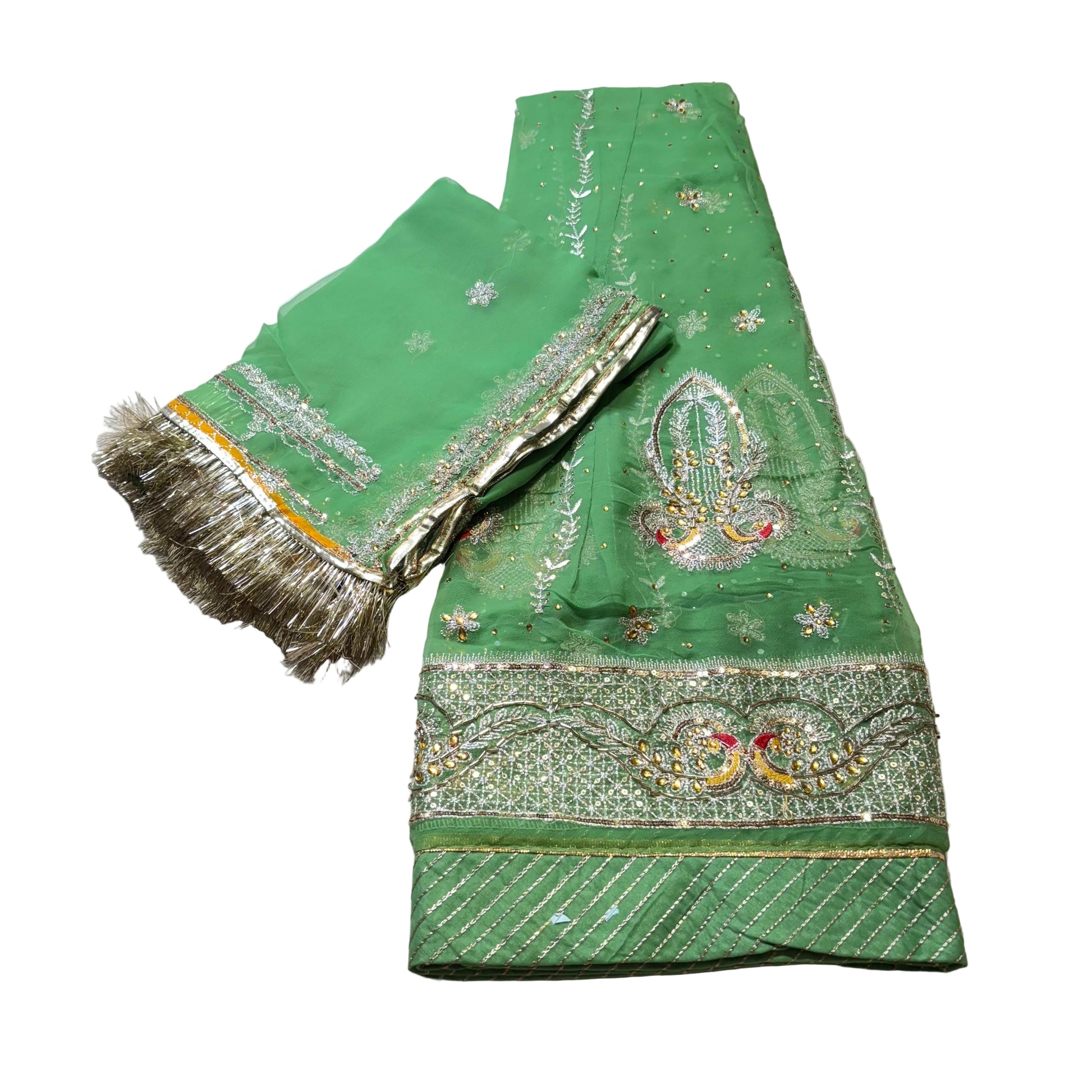 Green embroidered fabric with gold detailing on a light gray background