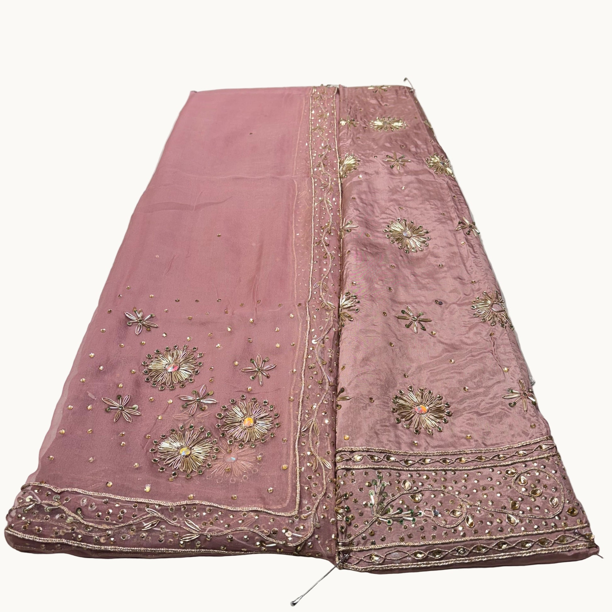 Pink embroidered fabric on a white background