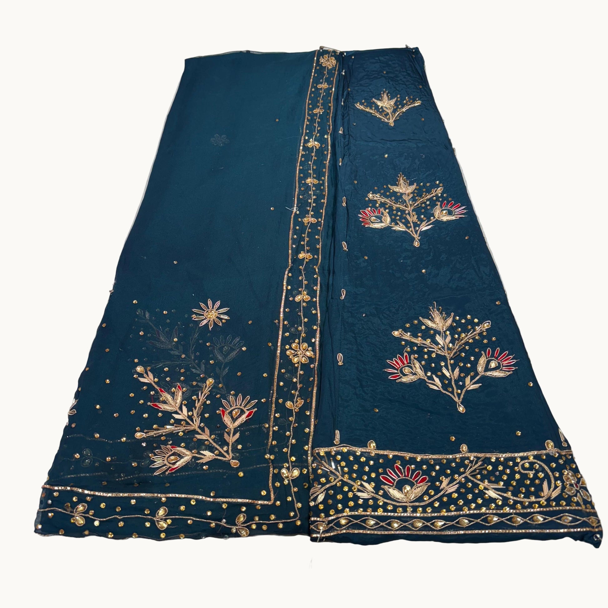 Dark blue fabric with gold embroidery on a light gray background