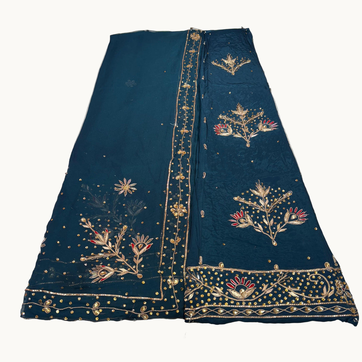 Dark blue fabric with gold embroidery on a light gray background