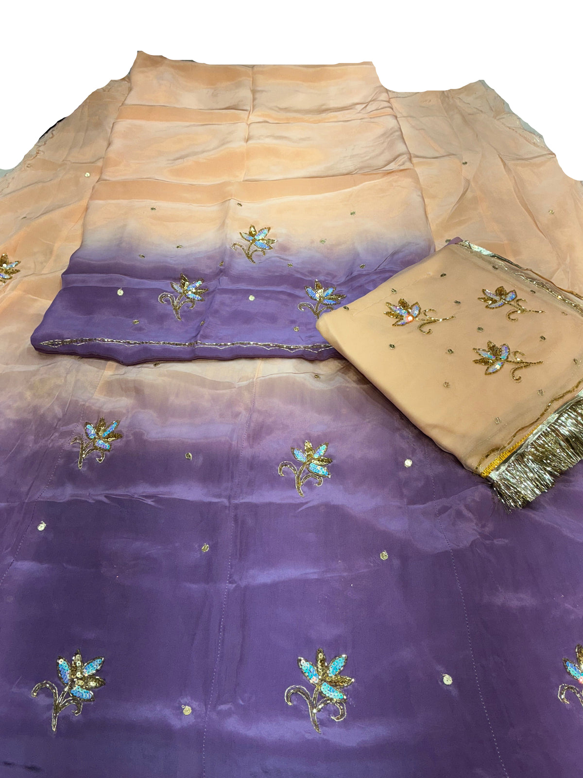 Peach colour Rajputi poshak fabric set, peach shading down to purple, with sequin flower butti and a matching peach odhni with golden fringe