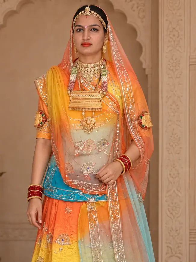 Shaded orange and sky blue pure odhni draped over the head, with zardozi bel border