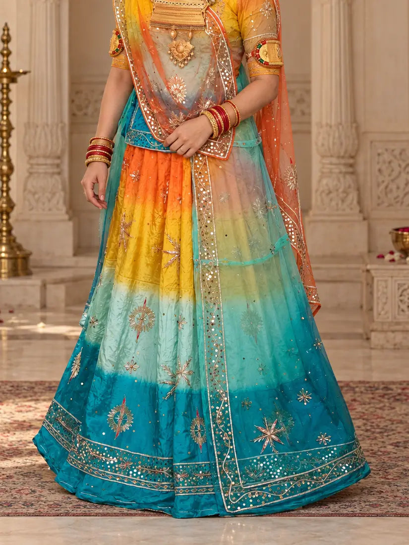 Lehenga close-up with orange, yellow, aqua and firozi bands, zardozi star buttis and wide sequin hem border