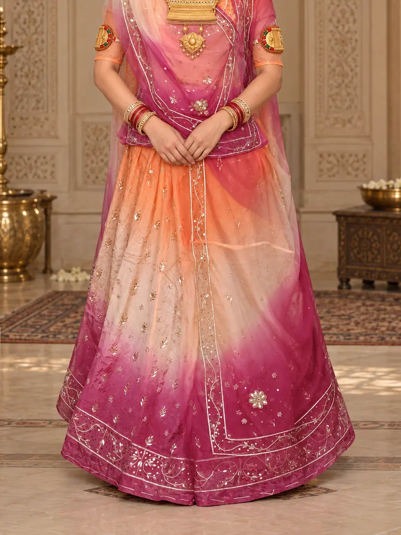 Lehenga close-up with orange, cream and rani pink bands, small zardozi leaf buttis and a sequin bel hem border