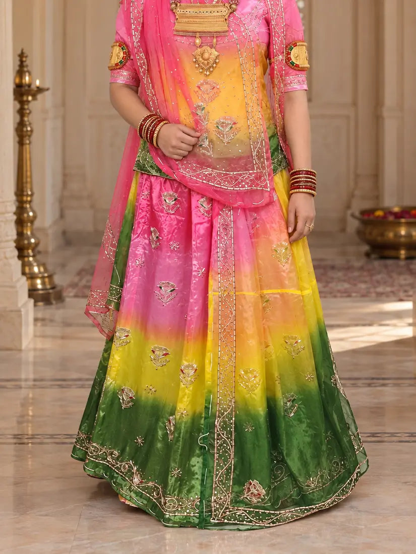 Lehenga close-up with pink, yellow and dark green bands, zardozi flower buttis and bel hem border