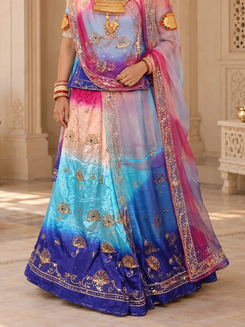 Lehenga close-up with peach, sky blue and royal blue bands, zardozi buttis with blue stones and bel hem border