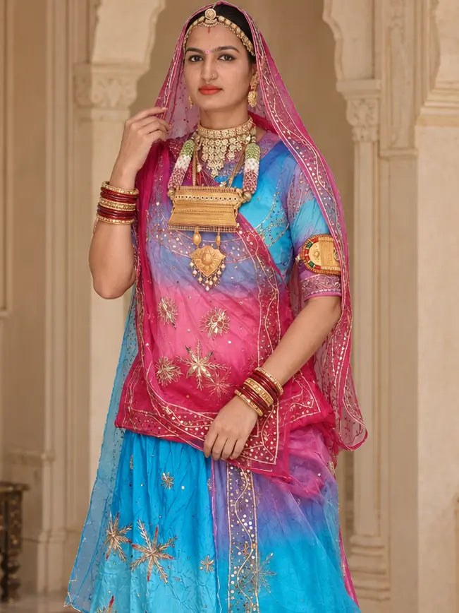 Sky blue to rani pink shaded kurti with zardozi stars, rani pink odhni with sequin border draped over the head