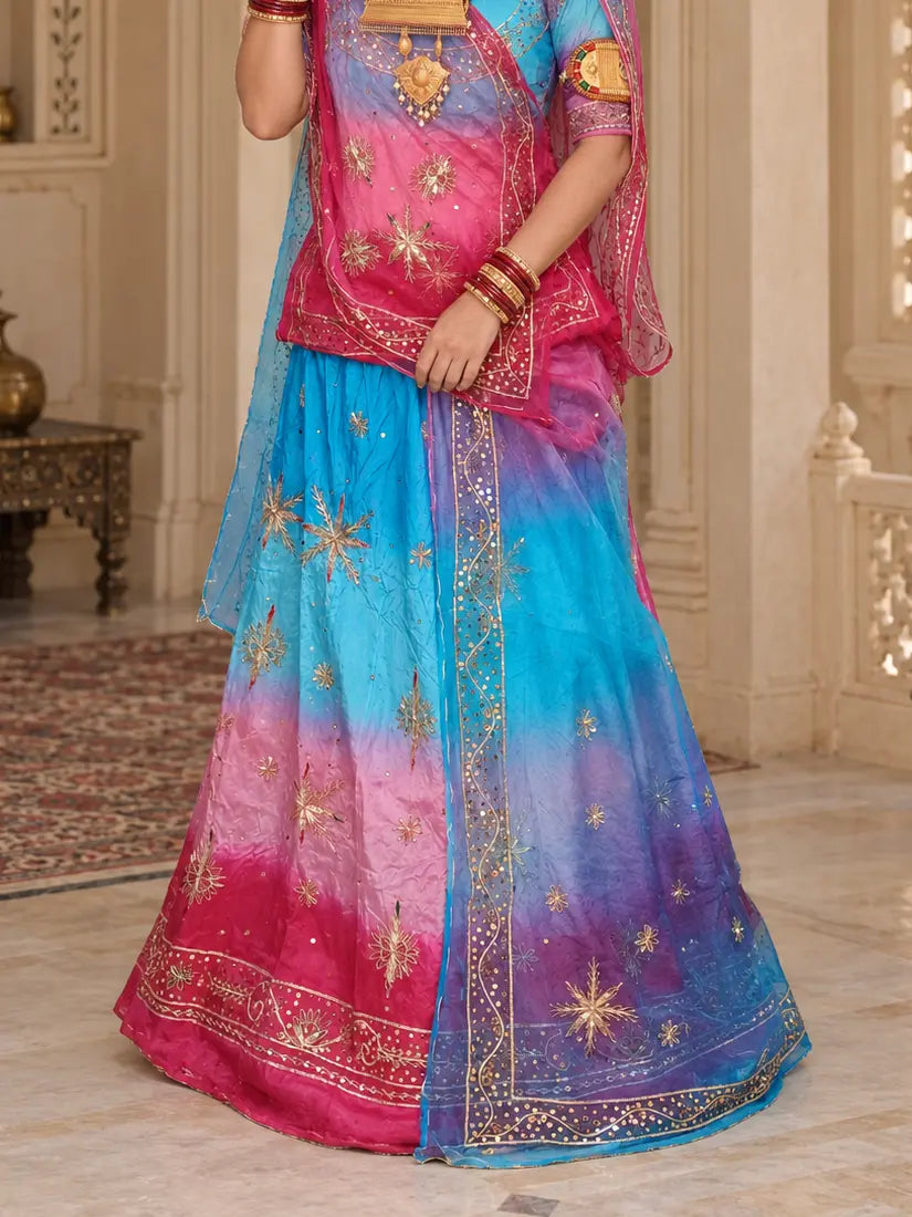 Lehenga close-up with sky blue, light pink and rani pink bands, zardozi star buttis and wide sequin hem border