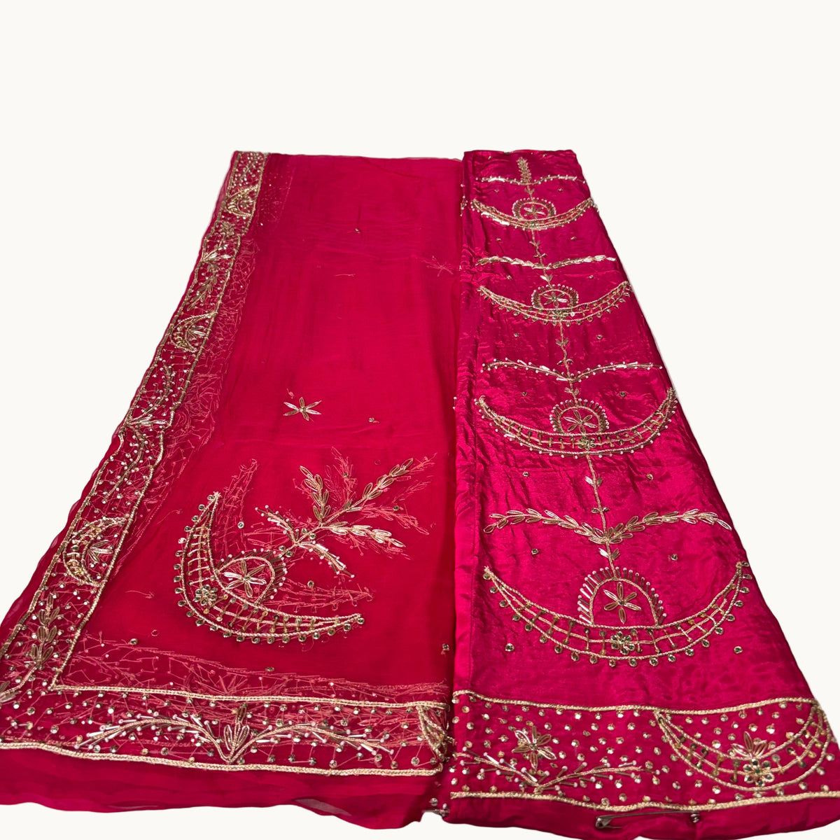 Red embroidered fabric on a white surface