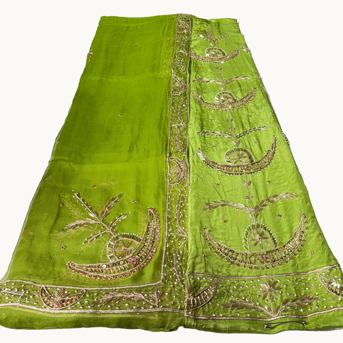 Green embroidered fabric on a white background