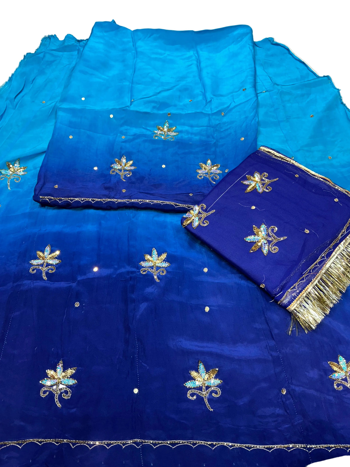 Blue shaded Rajputi poshak fabric set, sky blue top deepening to royal blue, with sequin flower butti and a royal blue odhni with gold fringe