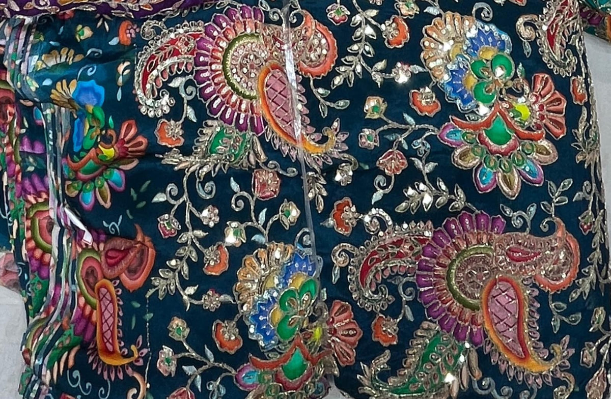 Decorative fabric with colorful paisley patterns on a dark background