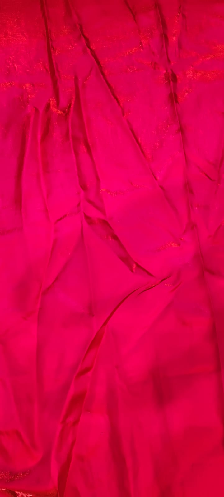 Close-up of bright pink fabric with a textured pattern