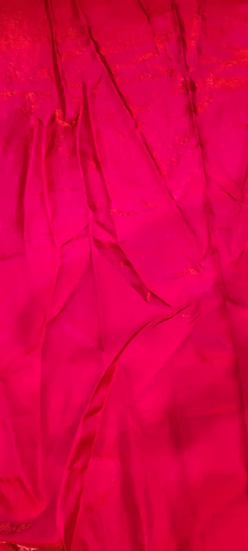 Close-up of bright pink fabric with a textured pattern