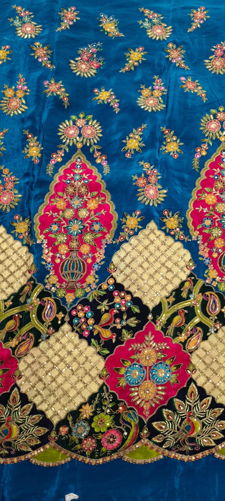 Decorative fabric with intricate patterns and colors on a blue background