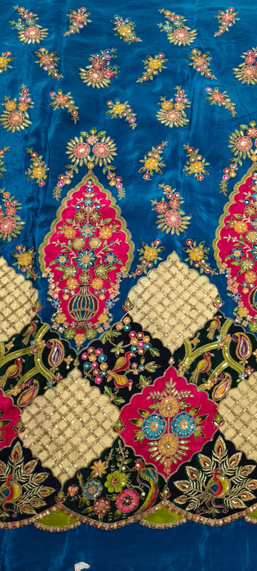 Decorative fabric with intricate patterns and colors on a blue background