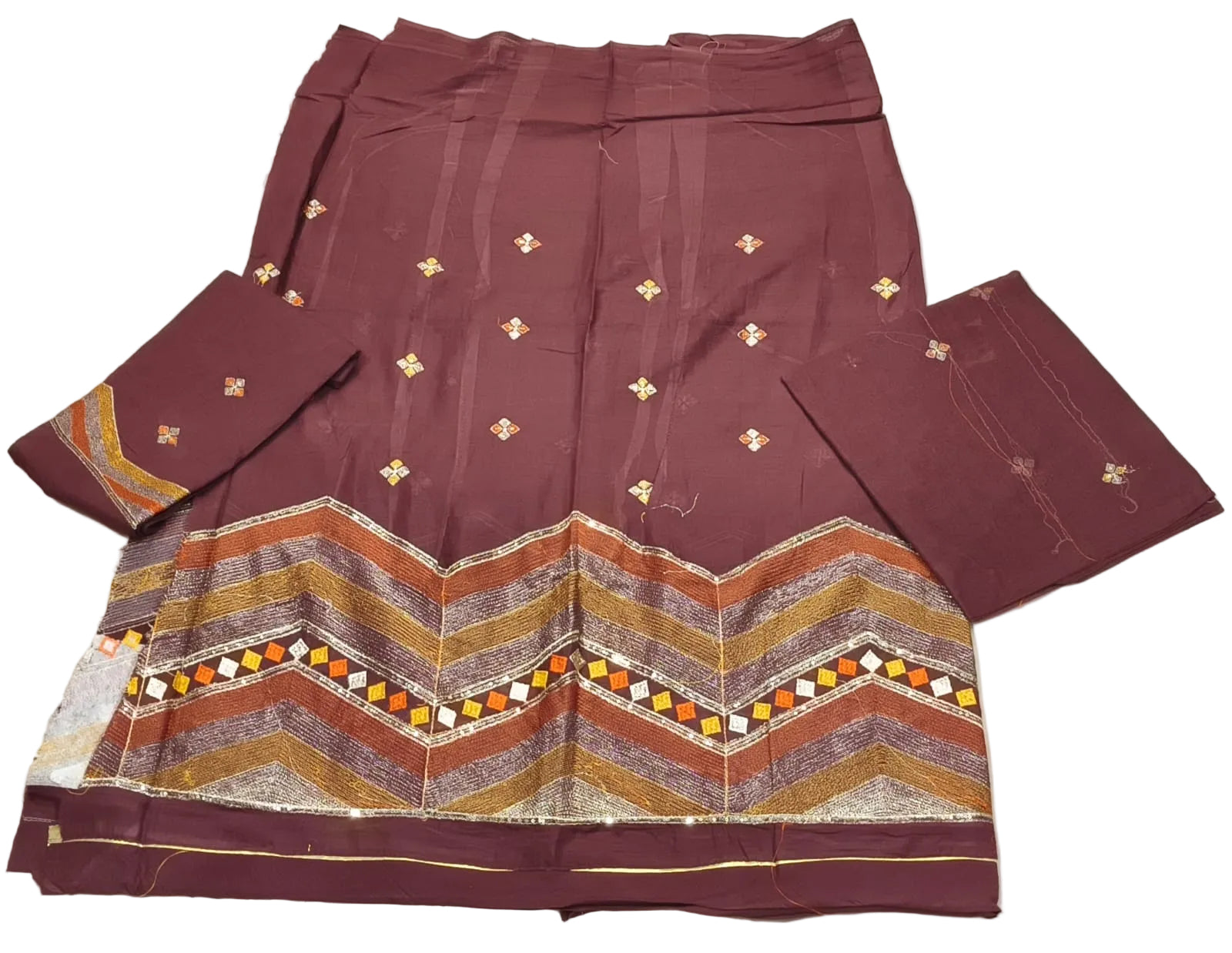 Maroon traditional outfit with geometric patterns on a white background