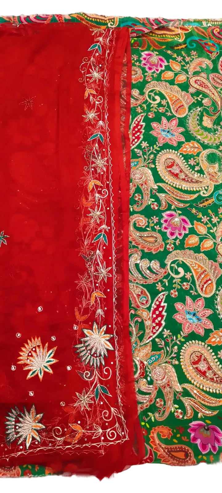 A traditional Indian ethnic garment, likely a saree or dupatta, featuring a vibrant red border with intricate gold, white, and green embroidery, and a green body adorned with colorful paisley and floral patterns.