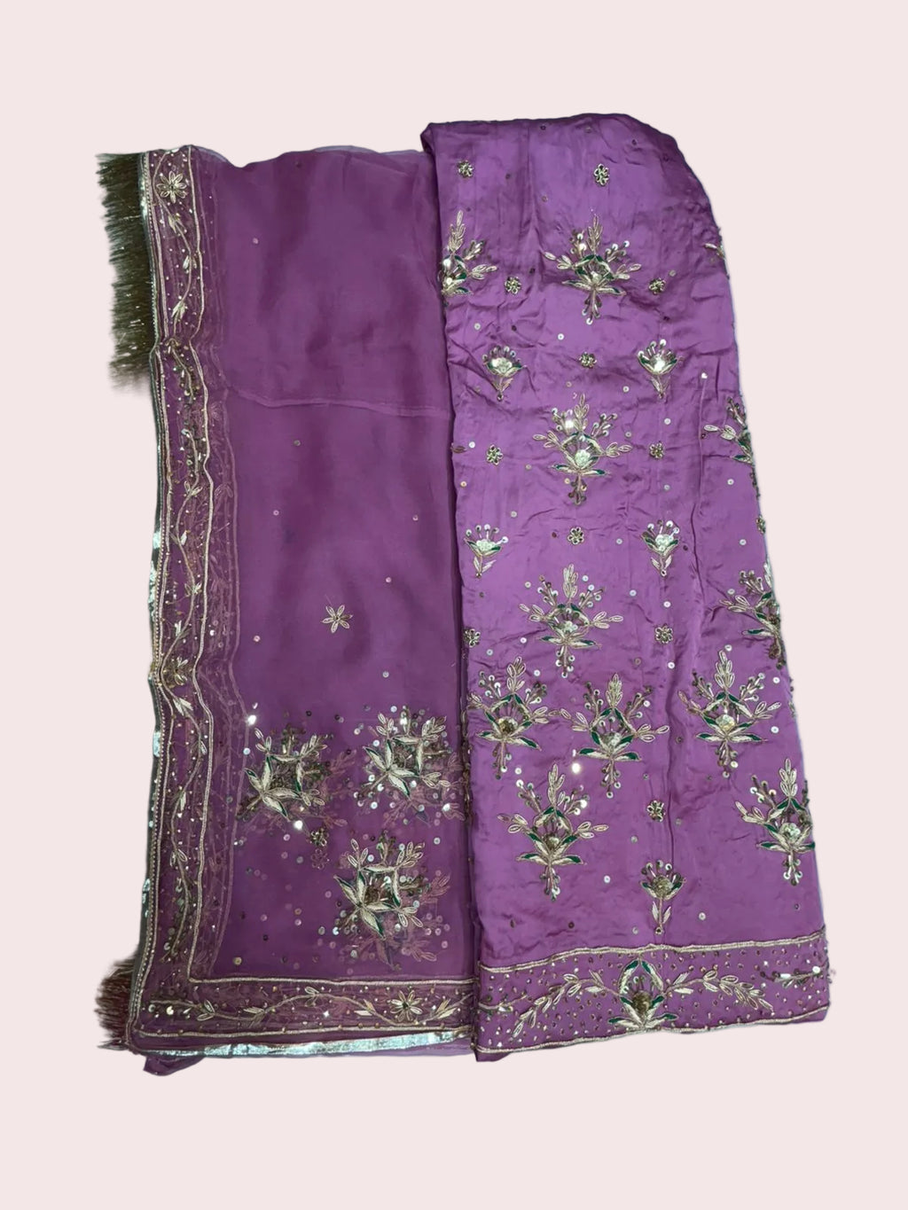 Purple fabric with gold embroidery on a white background