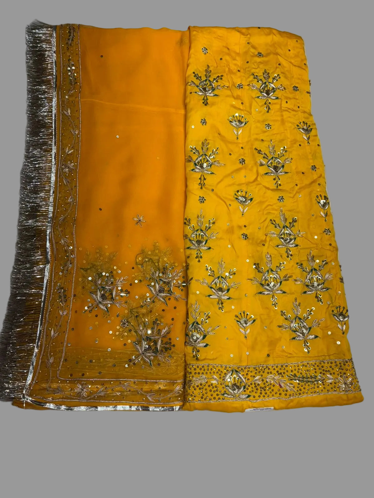 Yellow fabric with intricate gold embroidery on a white background