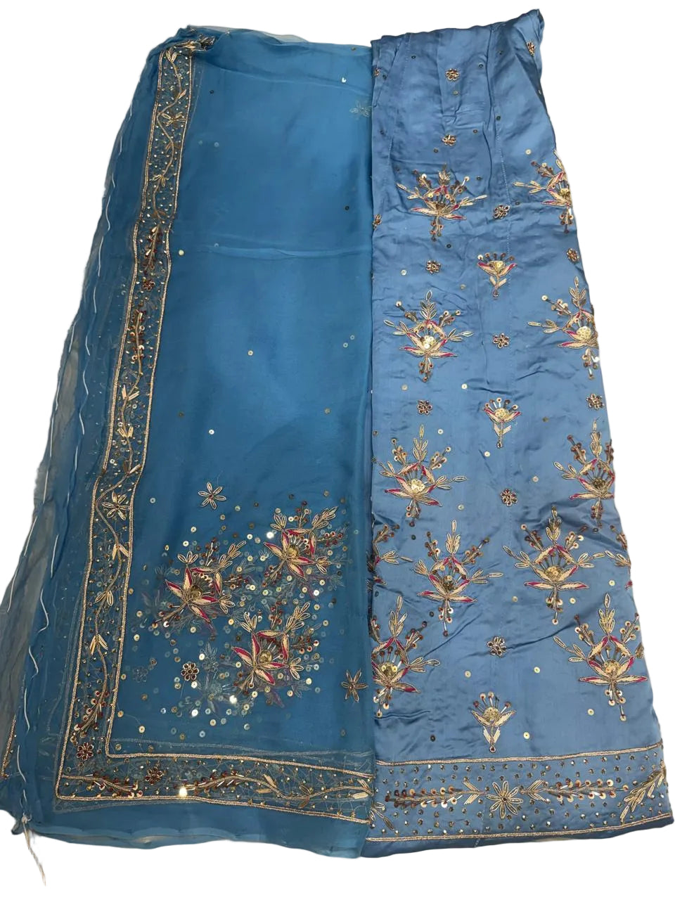 Blue embroidered fabric on a beige surface