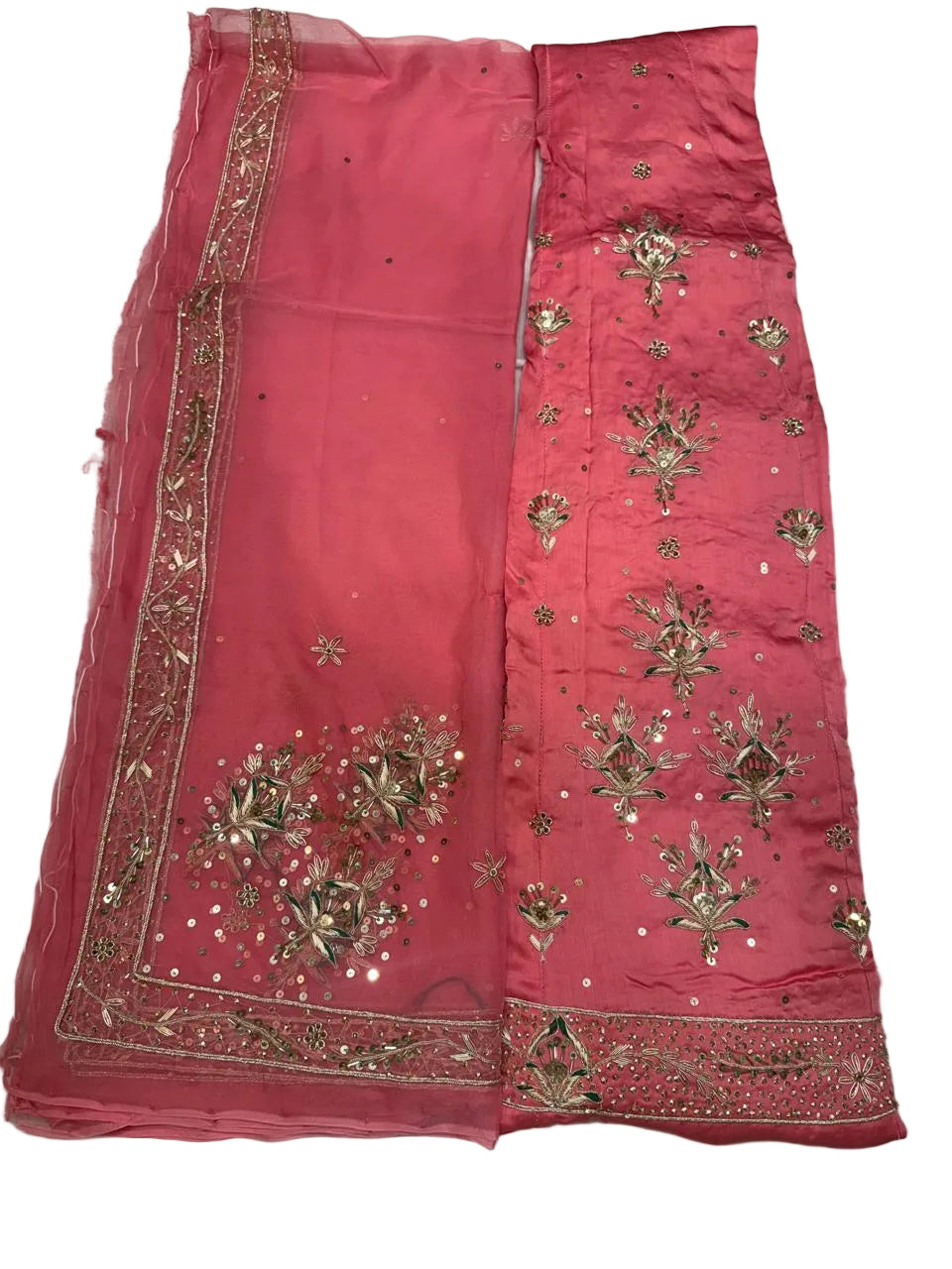 Red fabric with gold embroidery on a light gray surface
