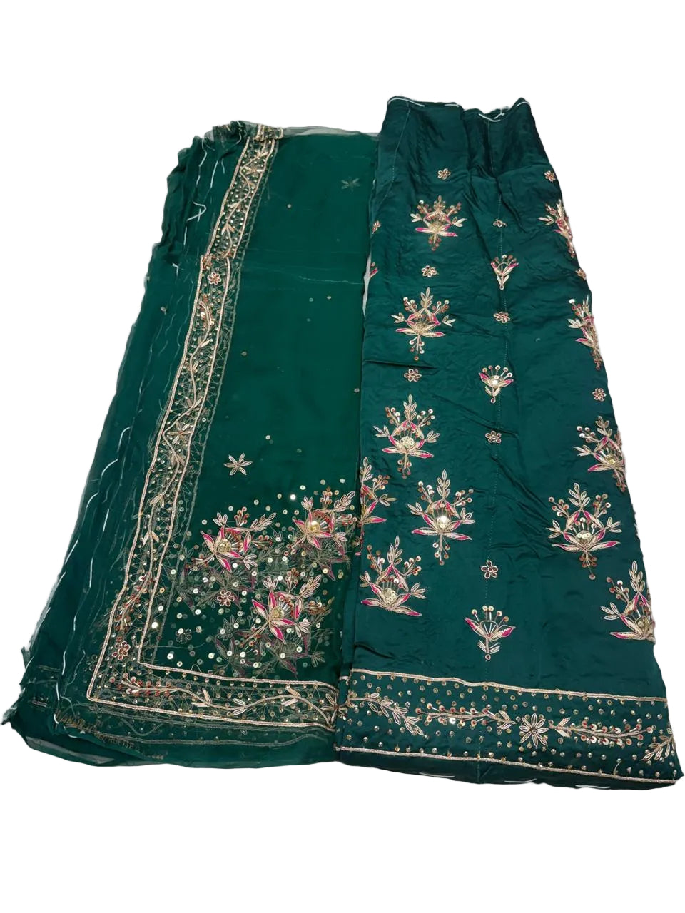 Green embroidered fabric on a white bedspread